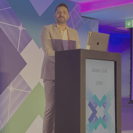 Alam Gill presenting at a conference